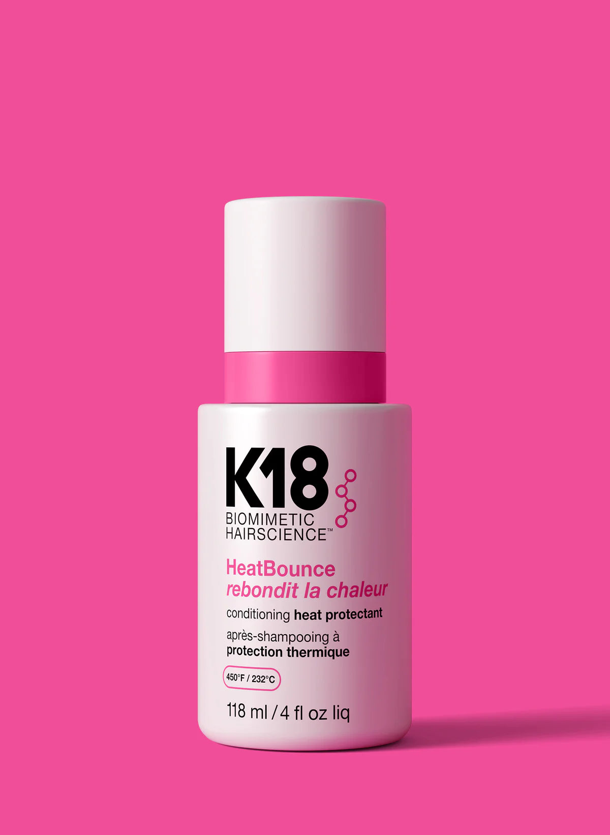 K18 HeatBounce hair product bottle on a pink background